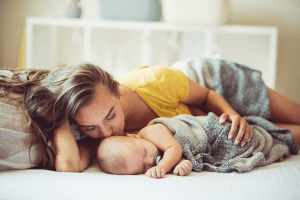 Mom with Chronic Fatigue Syndrome resting while baby is sleeping